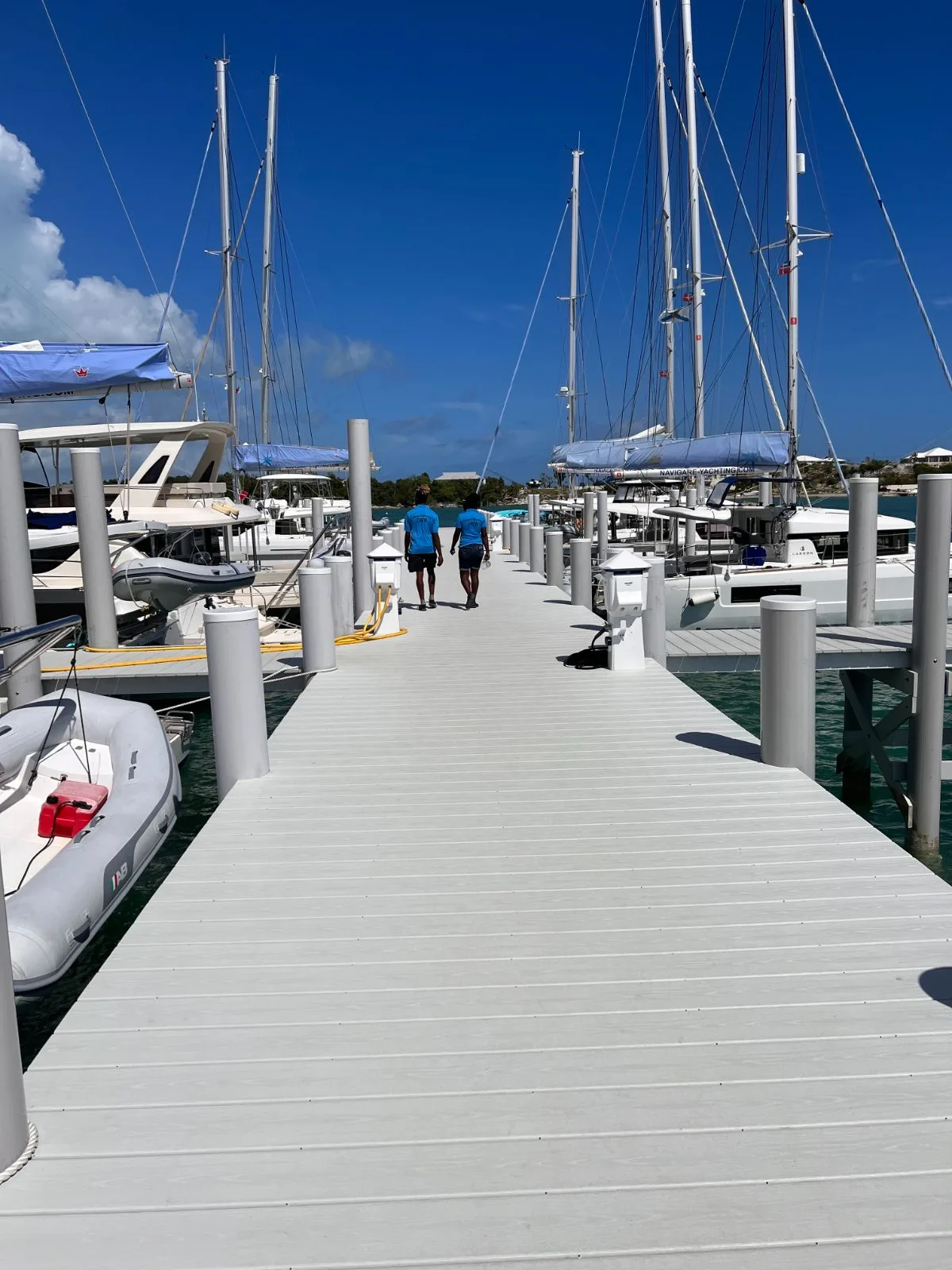 The composite dock at Conch Inn marina, catamarans tied up on both sides