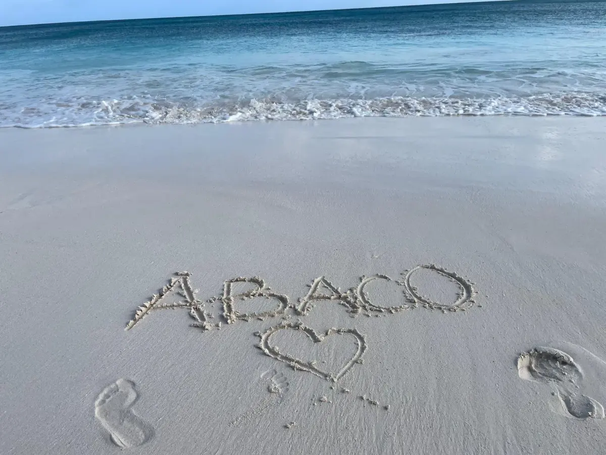 ABACO and a heart written in the sand at the water's edge