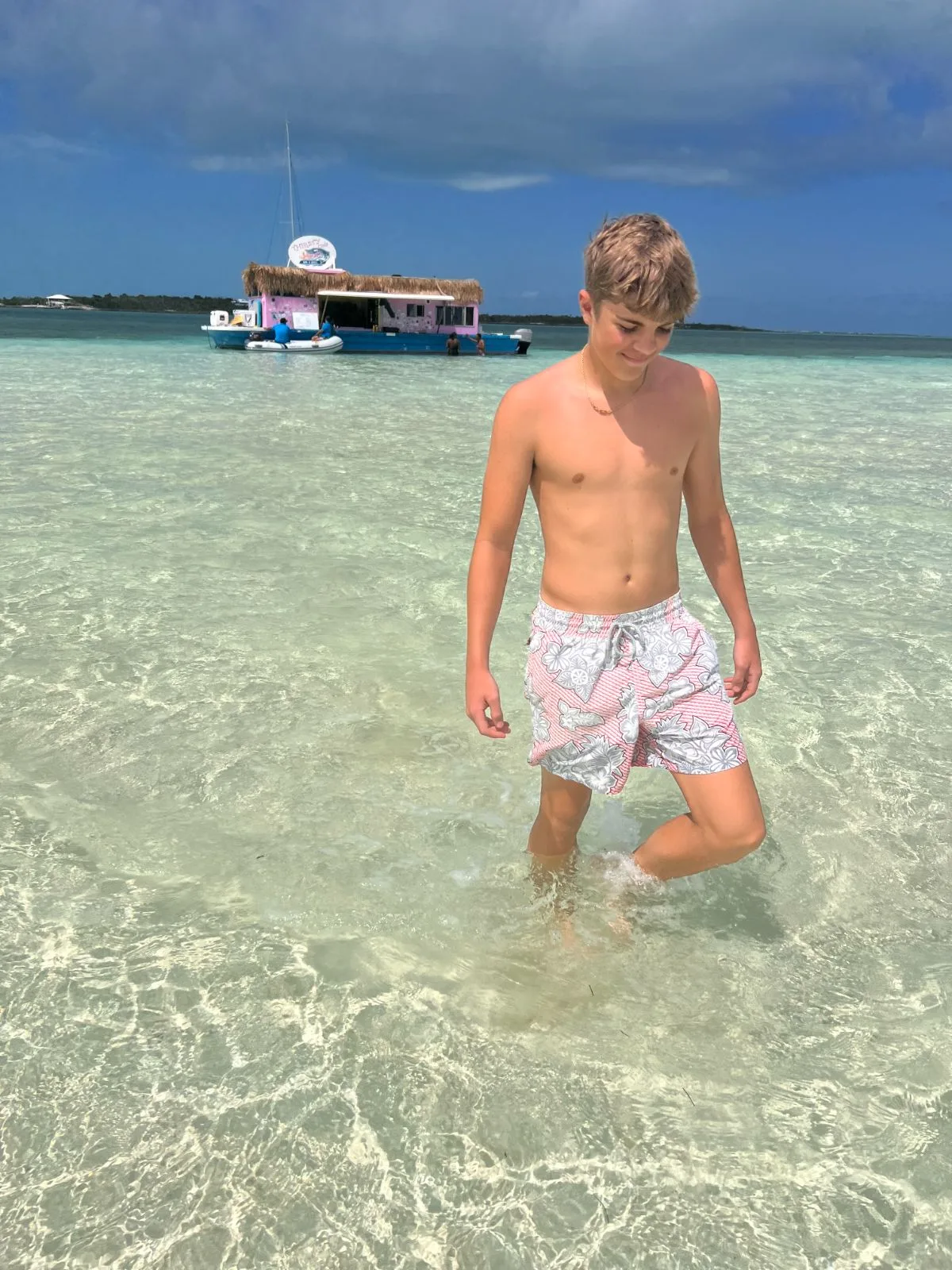 Wading on the Tahiti Beach sandbar with the Thirsty Cuda floating bar in the background