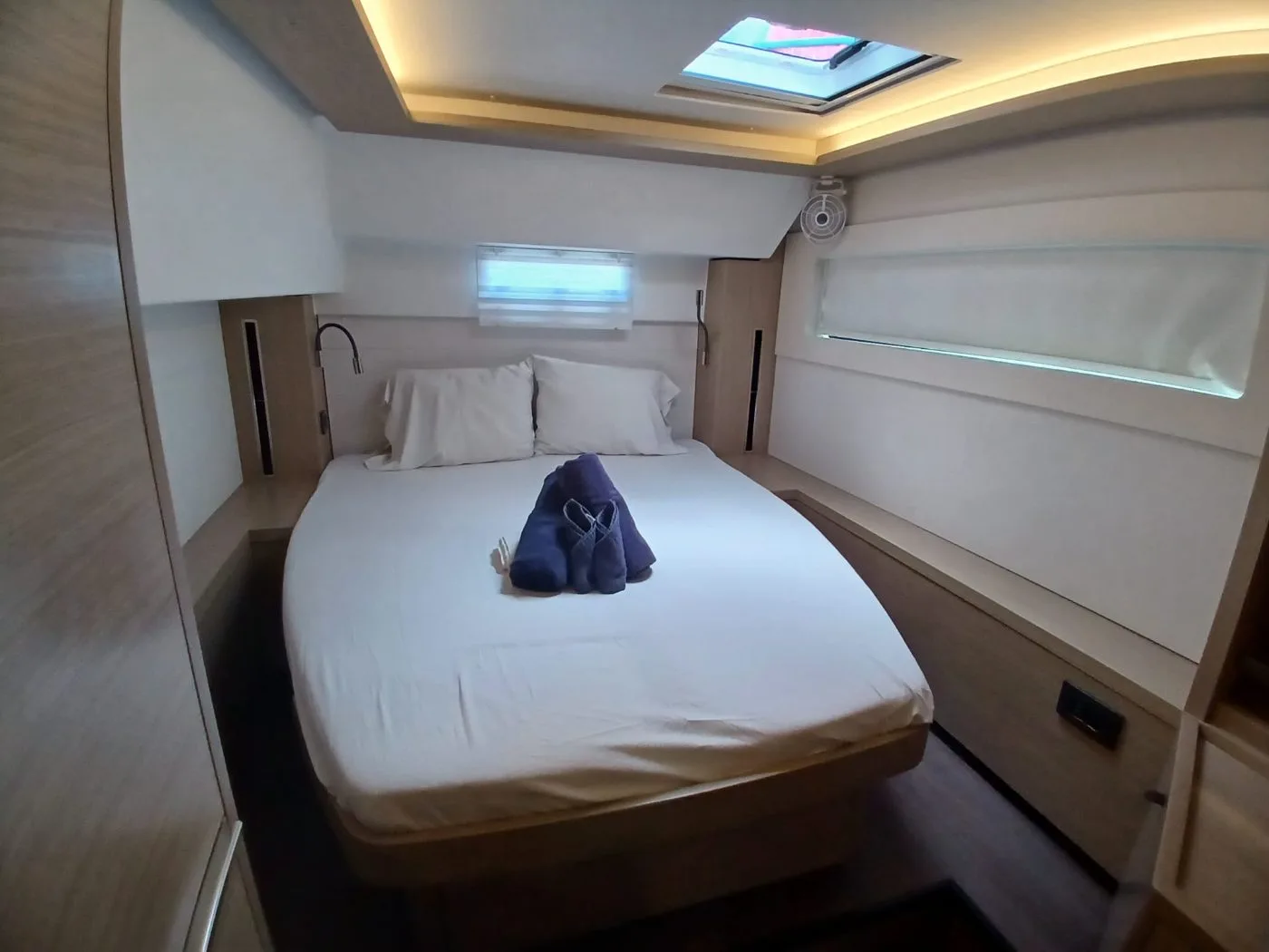 A double cabin aboard C U Sailing II with island berth and hull windows