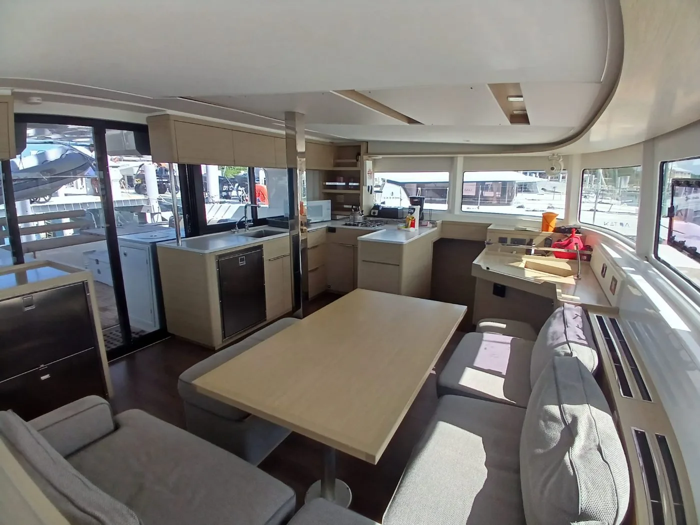 The saloon and galley of C U Sailing II, opening aft to the cockpit
