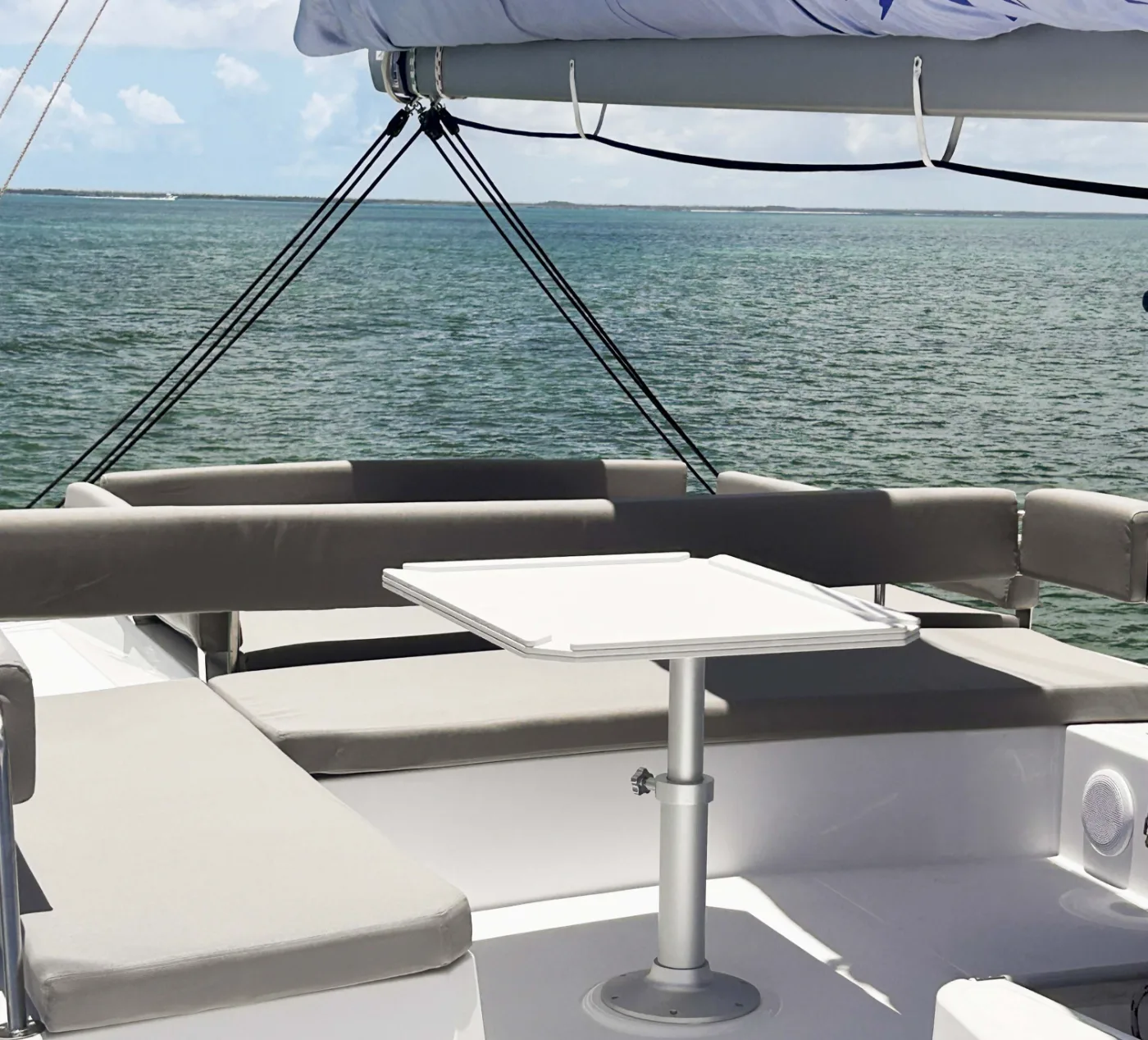 The flybridge of Exodus, sunpads and table under the boom