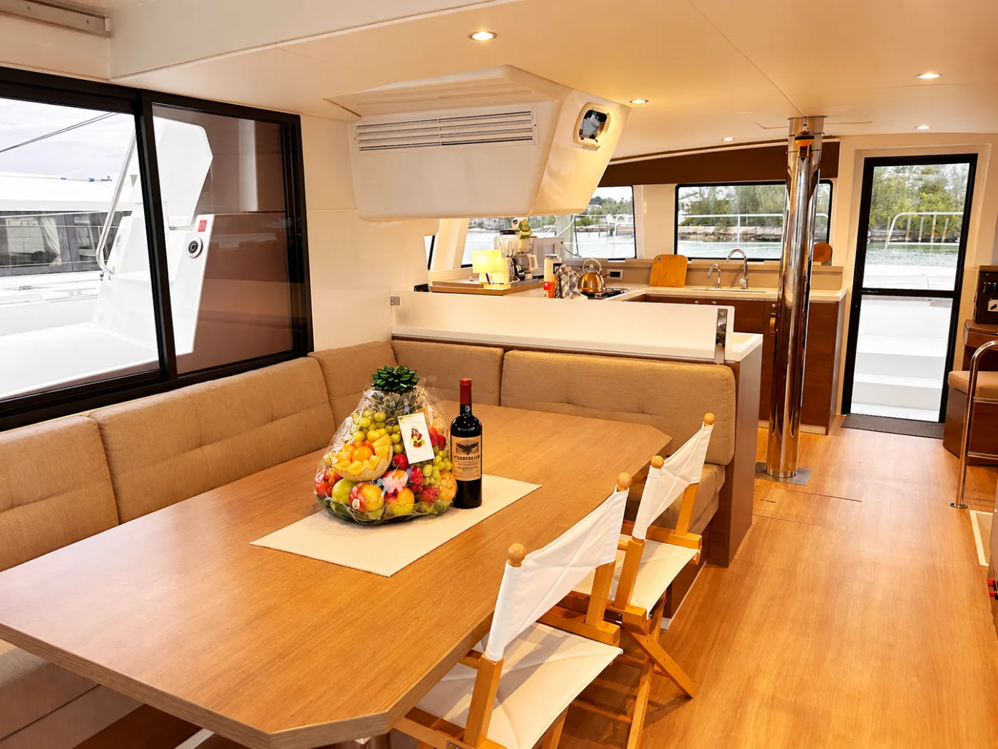 The saloon dining table aboard Exodus, set with a welcome fruit basket
