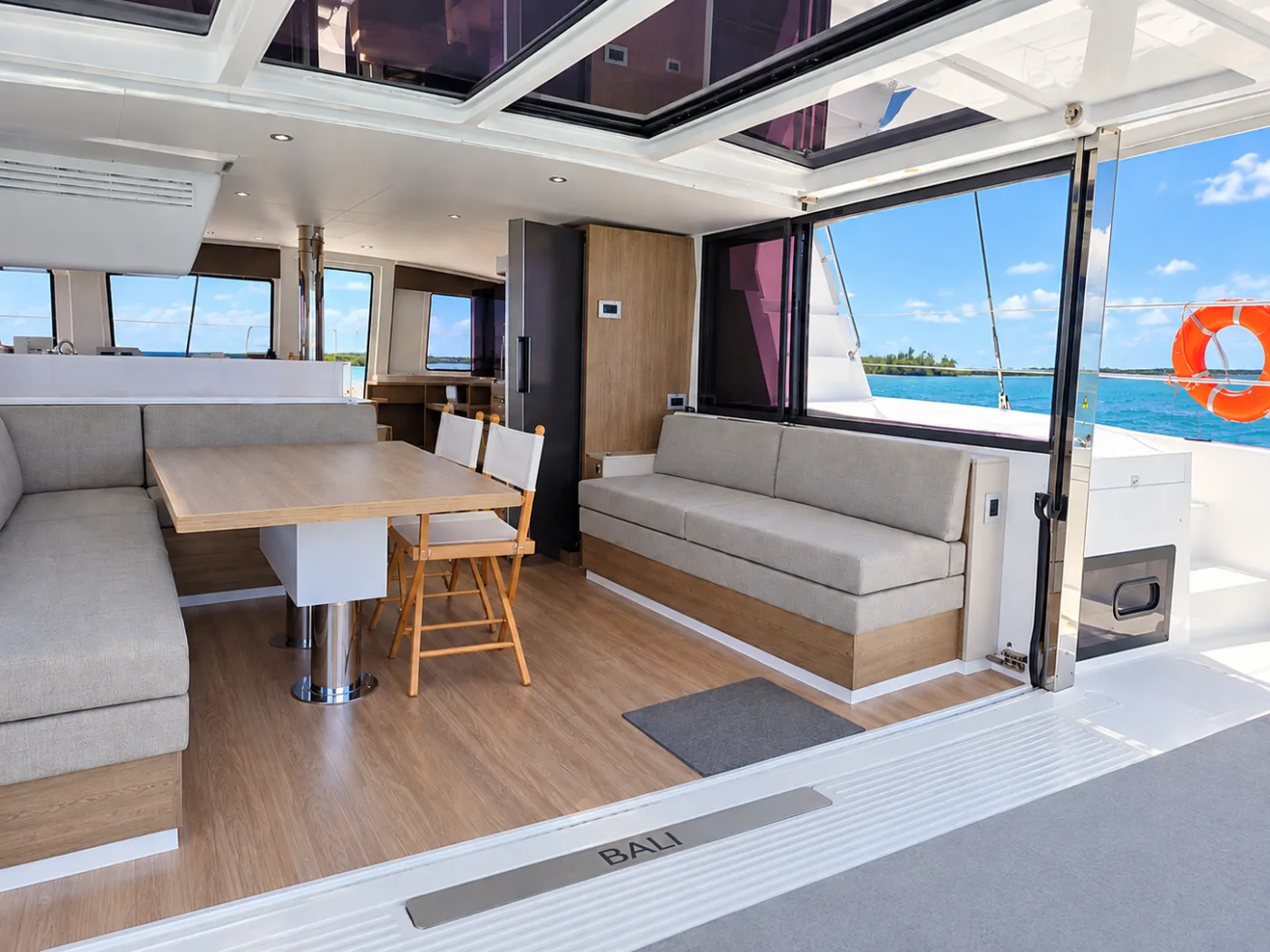The saloon of Exodus with the glass garage door lifted, open to the cockpit
