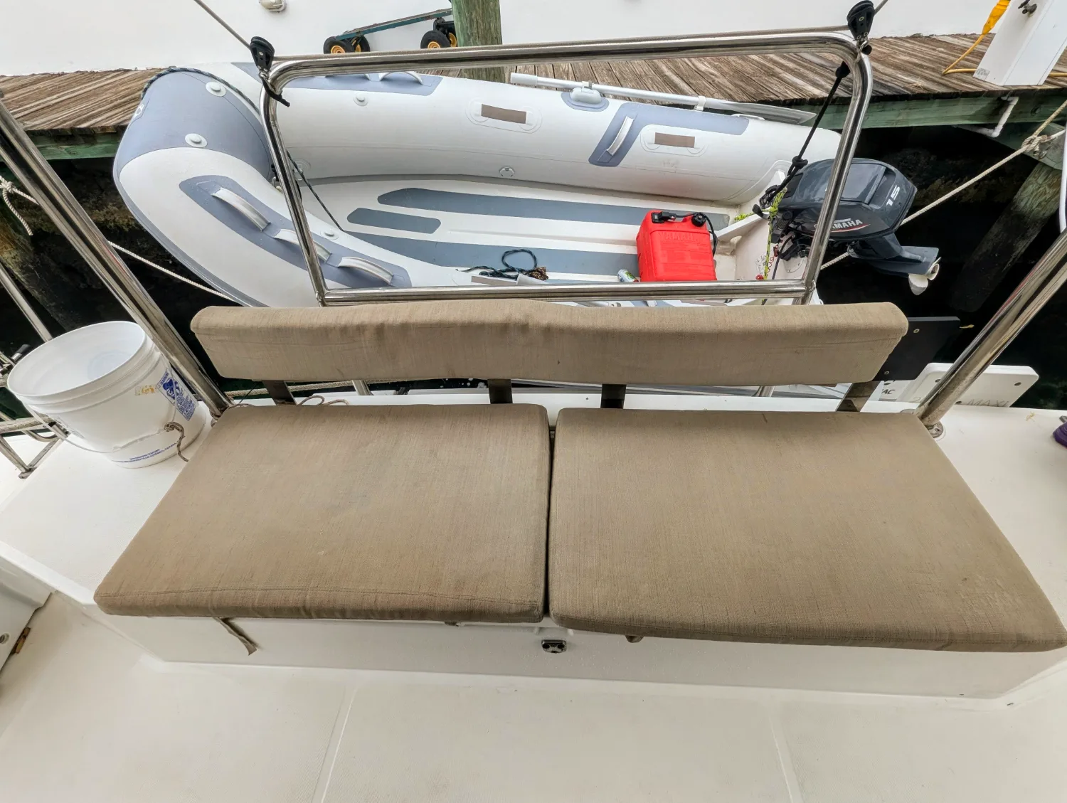 The aft cockpit bench of Let's Geaux with the dinghy astern