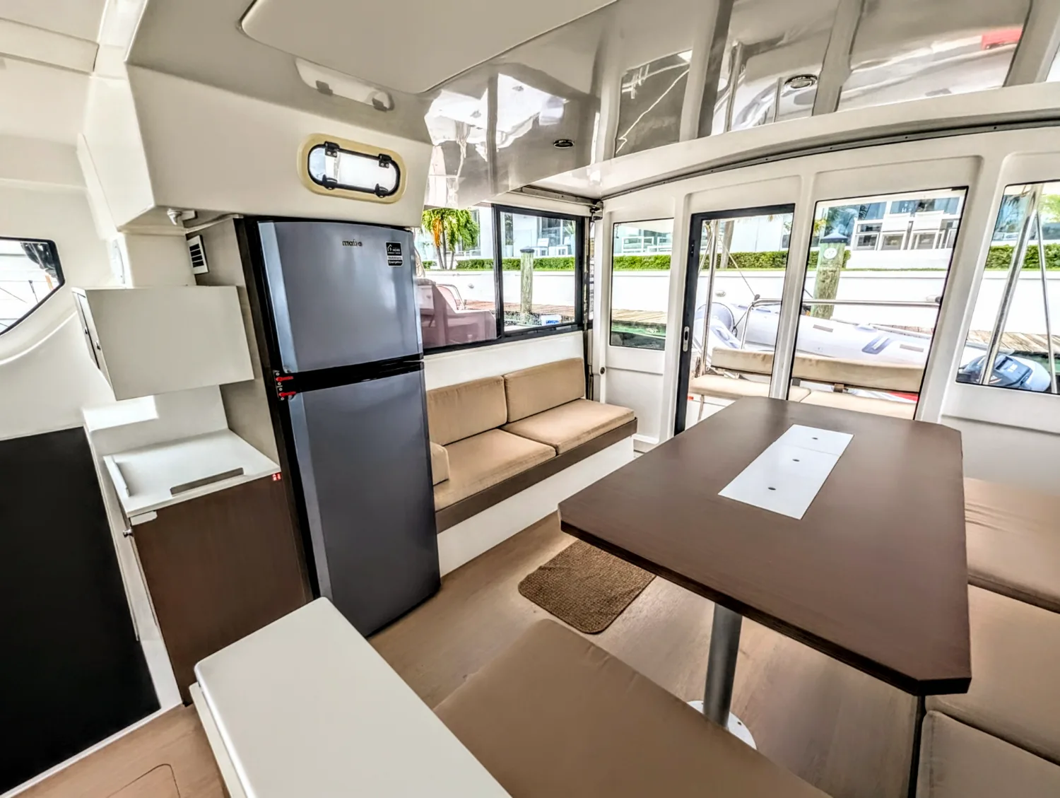 The saloon dining table and settee aboard Let's Geaux