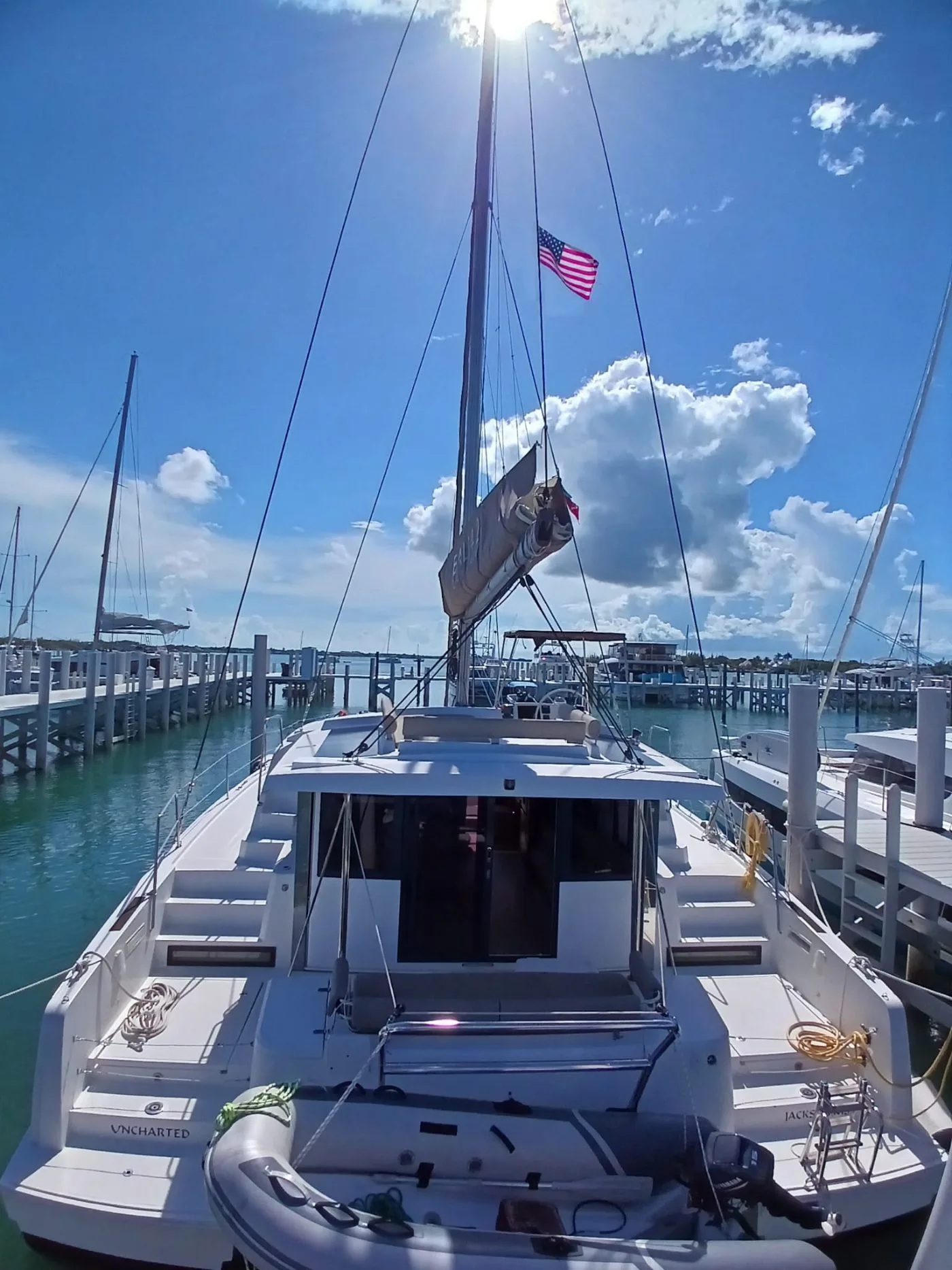 Uncharted seen bow-on from the dock, her name on the transom